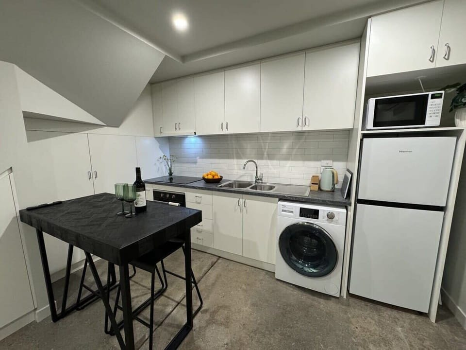 Kitchen has microwave and combined washer/dryer