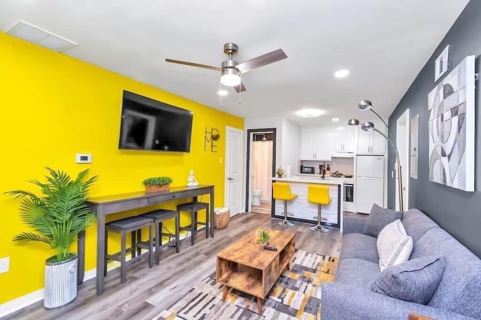 Sofa, coffee table, fast wi-fi,Smart TV, Modern Art, and Central Air Conditioning in the Living Room.