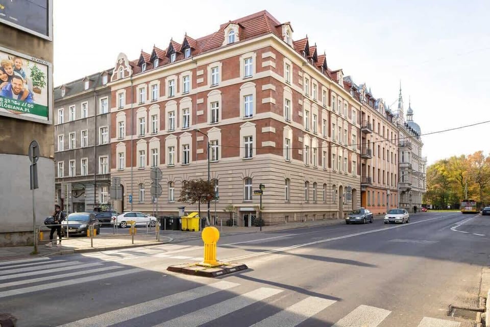 A street view of the historic brick building, displaying its classic architecture and the bustling city scene around it.







