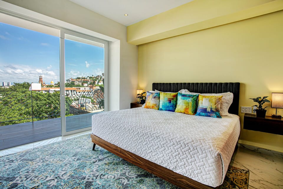 The guest bedroom has a comfortable king-size bed and panoramic view