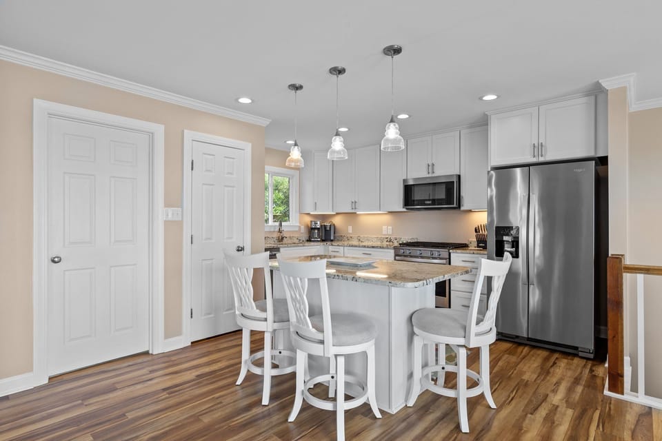 Whip up your favorite meals in this bright modern kitchen with granite counters, stainless appliances, and a cozy breakfast bar.
