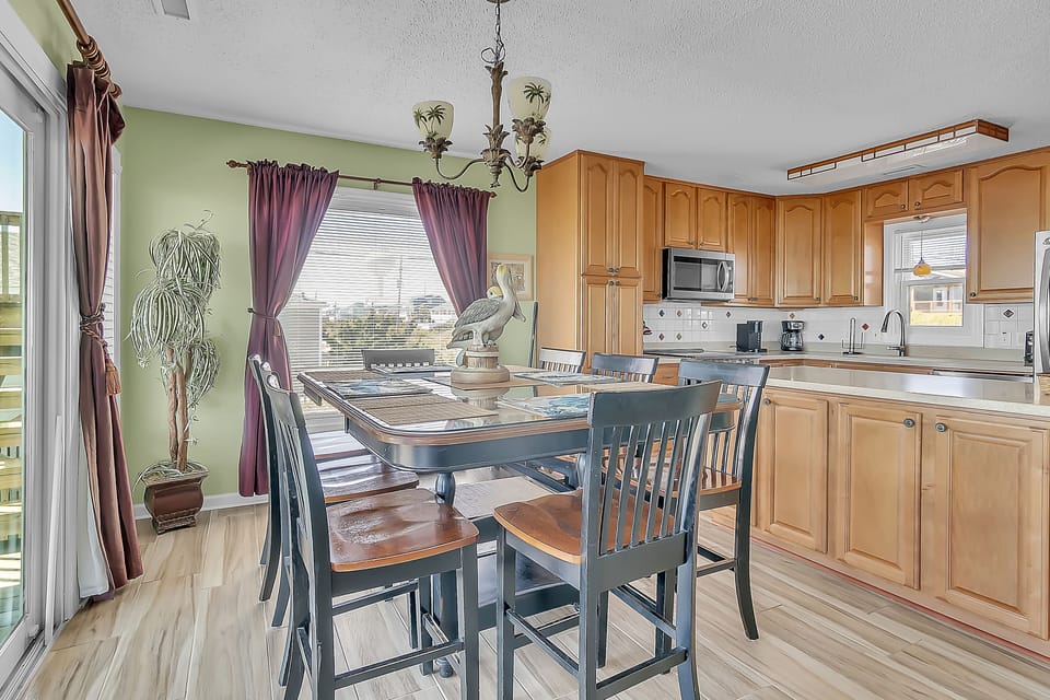 Your spacious kitchen flows into a charming dining area where you'll enjoy meals around the elegant table with warm natural light.