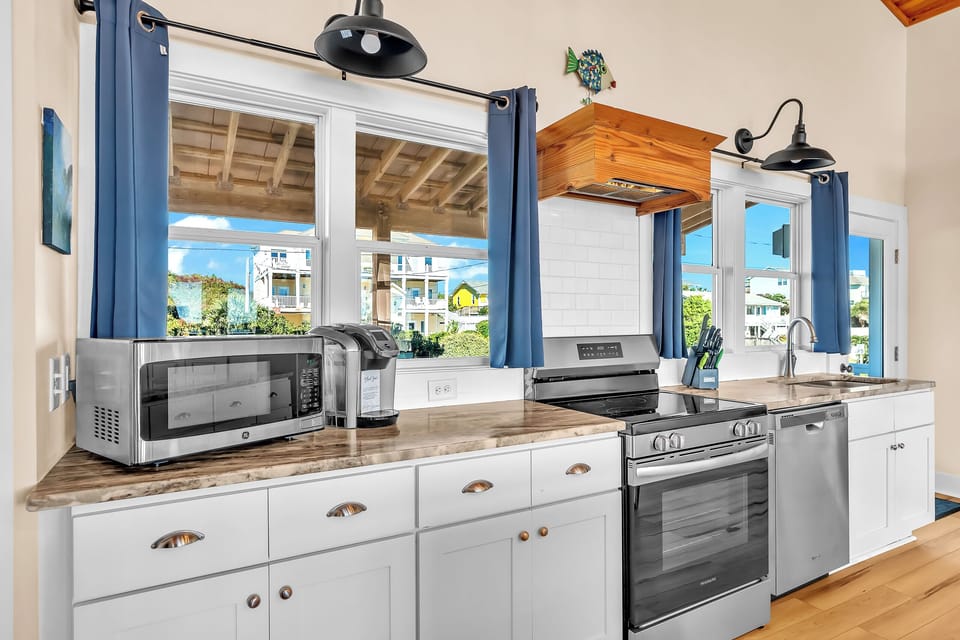 Your fully equipped kitchen features modern appliances and charming coastal views, perfect for preparing memorable meals during your stay.
