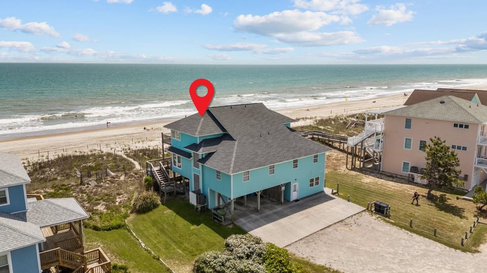 Oceanfront property directly on pristine beach with wooden walkway access and sea views.