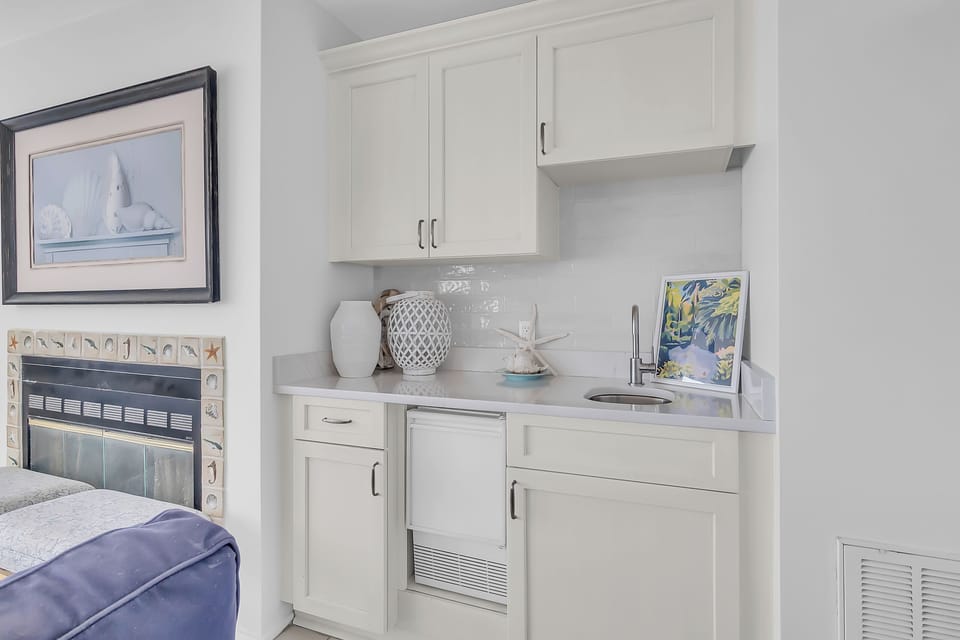 Your bright kitchenette features crisp white cabinets and granite countertops, perfect for preparing snacks while you relax by the fireplace.