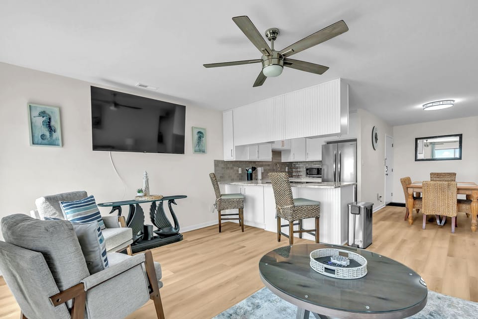 Relax in your bright, open-plan living space with modern coastal touches. Enjoy your fully-equipped kitchen, cozy seating, and stylish dining area—all yours to call home.