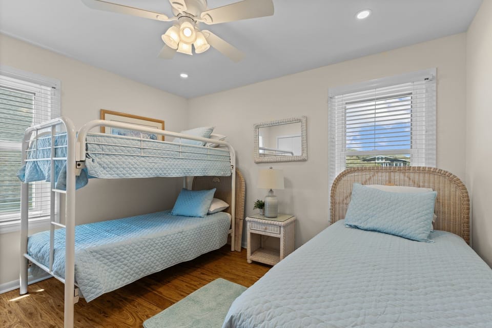 Your bright coastal bedroom features bunk beds and twin bed, perfect for kids or groups traveling together.