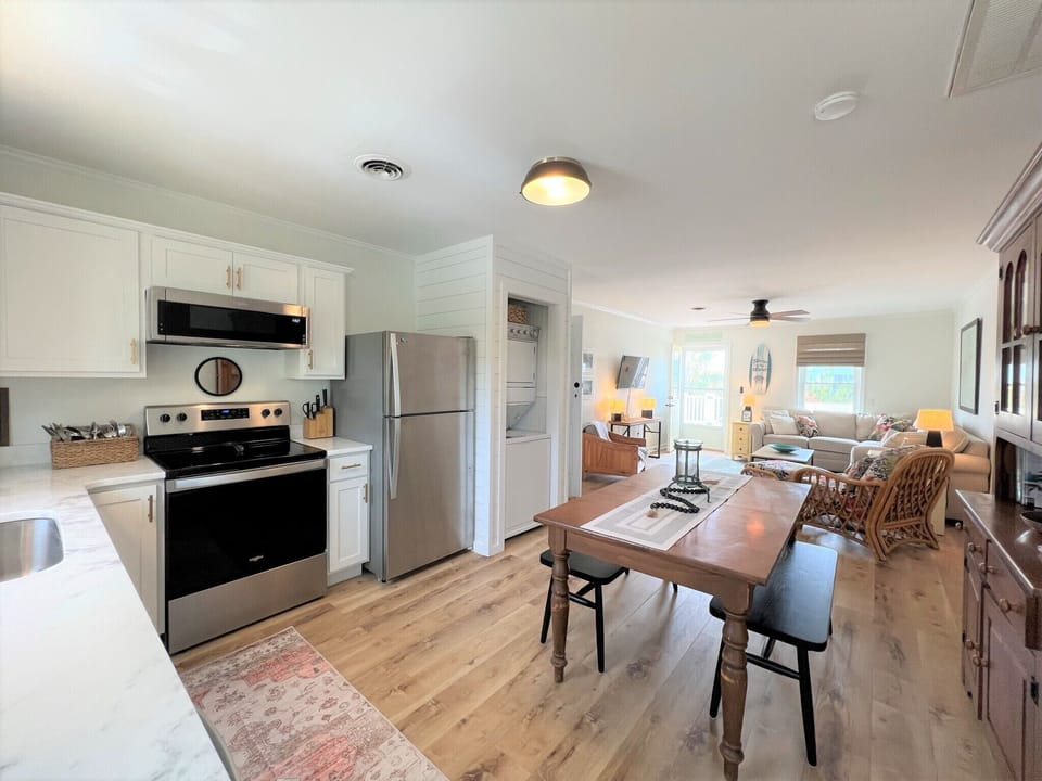 Step into your bright, open-concept retreat where the fully equipped kitchen flows seamlessly into your cozy living space.