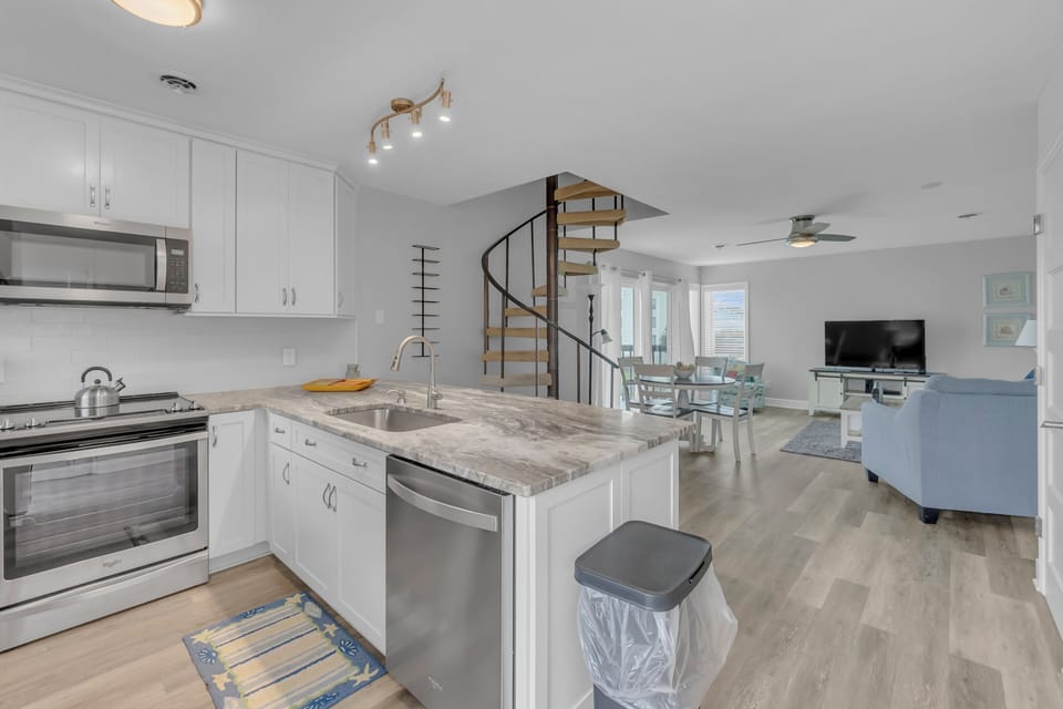 Your modern kitchen opens to the living space, featuring granite counters and stainless appliances for memorable meal prep.