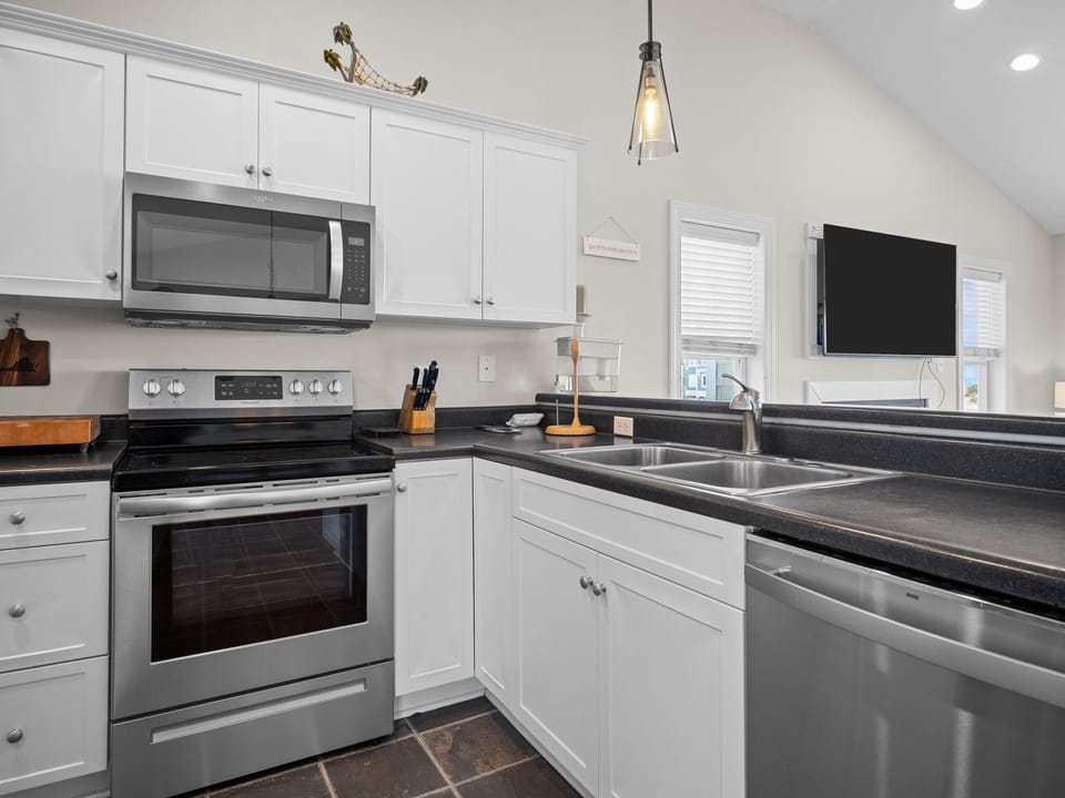 Your fully equipped kitchen awaits with sleek stainless appliances, granite counters, and everything needed to create memorable meals during your stay.