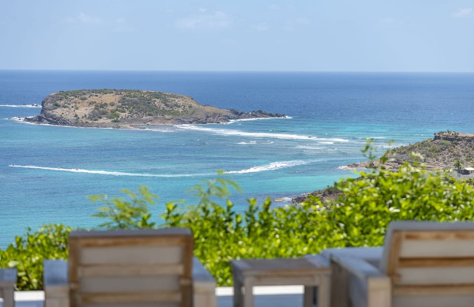 Lounge areas on the covered terrace, and at near the pool facing the view. 