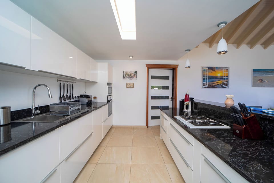 Air-conditioned kitchen equipped with electric oven, gas stove, microwave, fridge and freezer with ice maker, dish washer, toaster, regular filter coffee machine and Nespresso machine, electric kettle, blender, electric fruit squeezer. Inside dining table