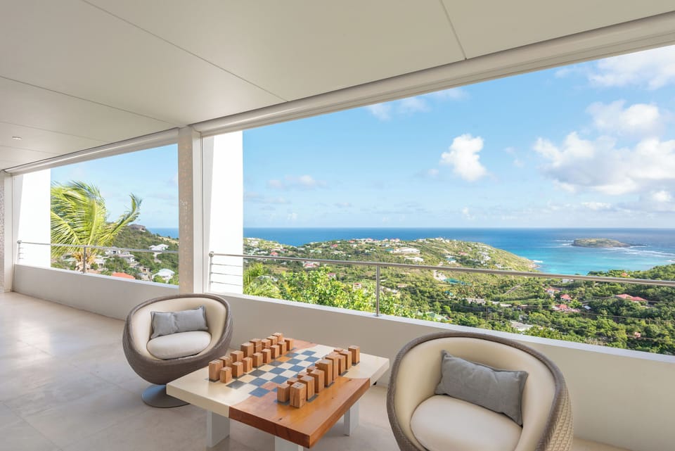Outdoor living-room on the covered terrace by the pool with sofas for eight people.