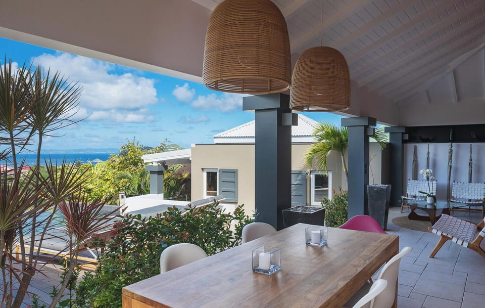 Modern and fully equipped kitchen. Coffee machine, dishwasher, espresso machine, gas cooker, microwave oven, oven, wine cellar. Outdoor dining table on the covered terrace. Another dining area is on the back, with the gas barbecue. 