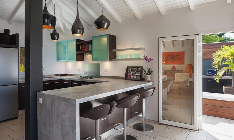 Modern and fully equipped kitchen. Coffee machine, dishwasher, espresso machine, gas cooker, microwave oven, oven, wine cellar. Outdoor dining table on the covered terrace. Another dining area is on the back, with the gas barbecue. 