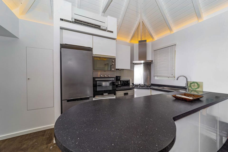 Air conditioned and fully equipped kitchen, electric oven and stove, refrigerator and freezer, microwave, dishwasher, coffee maker, Nespresso machine, mixer, toaster. Outdoor dining table on the covered terrace. 