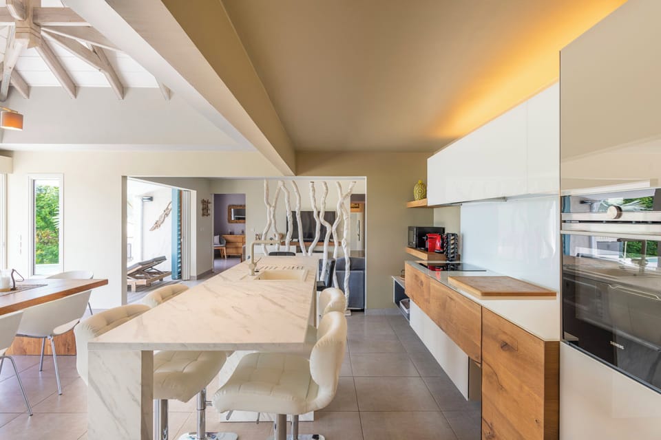 Modern, and fully equipped kitchen. Coffee machine, dishwasher, espresso machine, gas cooker, microwave oven, oven. Dining area for 6 people, facing the view. Ceiling fans. A second dining area for 6 people is located next to the great room, opening onto 