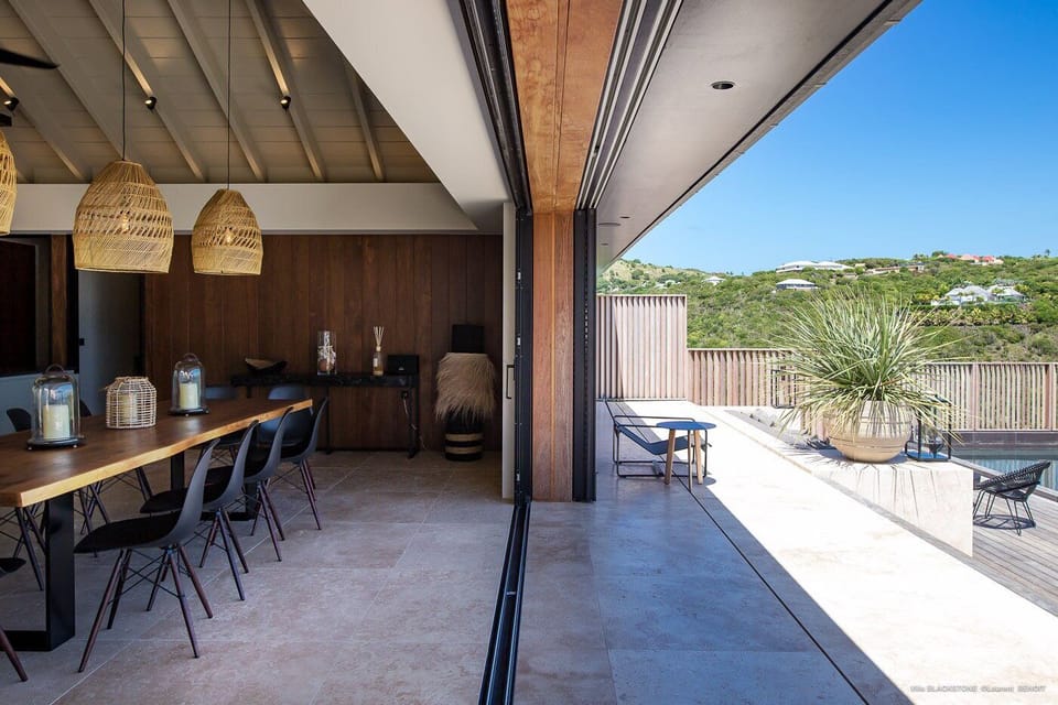 Indoor dining area with dining table for twelve people. Outdoor dining area near the pool, sofas and a rectangular wooden table covered with a parasol. Breathtaking views. 