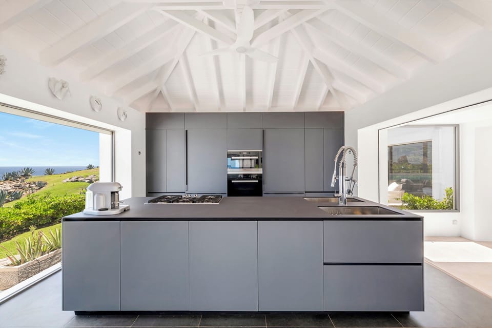 Two state of the art kitchens by Valcucine, renowned for its high technology and environmental friendliness. Refrigerator, freezer, ice machine, dishwasher, oven, microwave, Nespresso machine, toaster, mixer. 