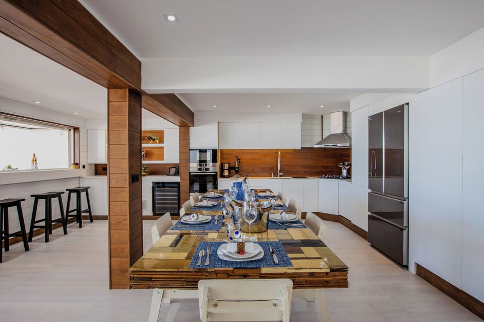 Fully equipped air-conditioned kitchen with electric oven, induction cooker, microwave, fridge and freezer, dishwasher, toaster, coffee maker, blender, electric kettle. Indoor dining table and outdoor table on the covered terrace. 