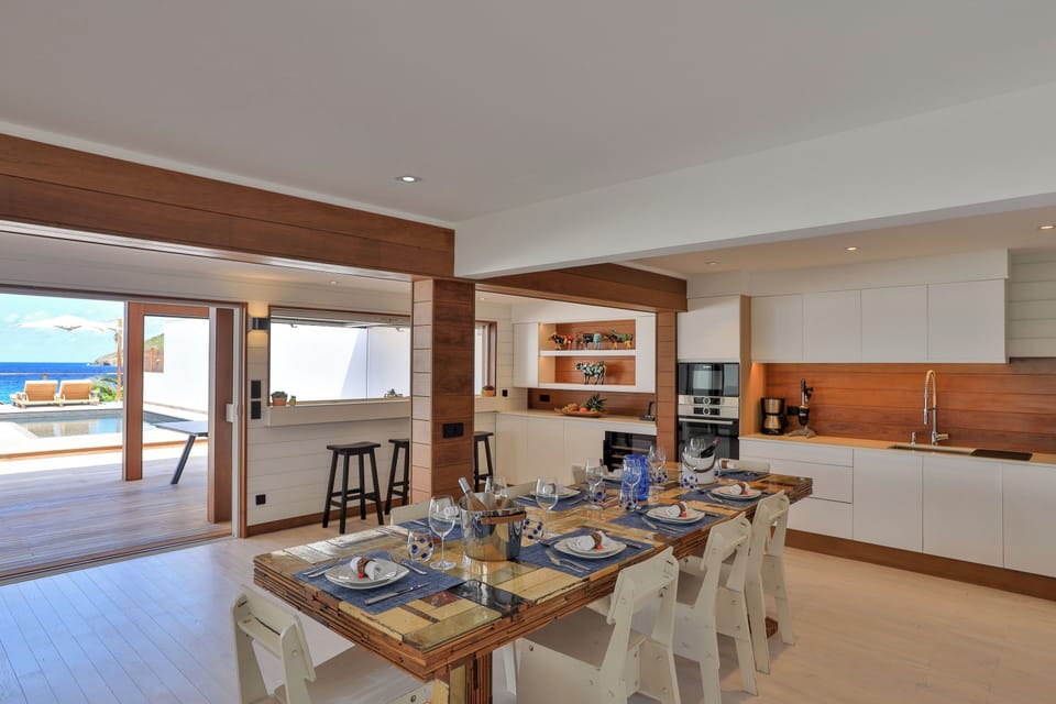 Fully equipped air-conditioned kitchen with electric oven, induction cooker, microwave, fridge and freezer, dishwasher, toaster, coffee maker, blender, electric kettle. Indoor dining table and outdoor table on the covered terrace. 