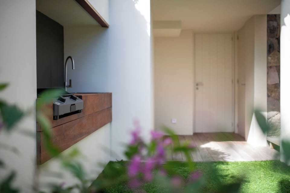Fully equipped kitchen, central island unit, fridge and freezer with ice machine, cooking range with gas burners, hood, microwave, dishwasher, filter coffee maker and espresso coffee machine, wine cooler, toaster. Outdoor wooden dining table on the back o