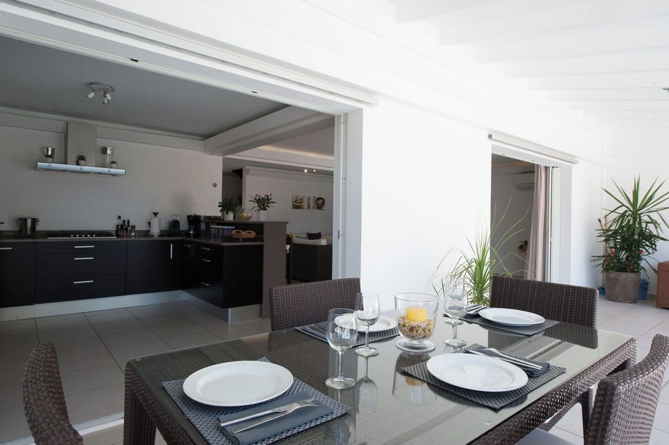 Fully equipped air-conditioned kitchen with electric oven, induction cooker, microwave, fridge and freezer, dishwasher, toaster, coffee maker, blender, electric kettle. Outdoor table on the covered terrace. 