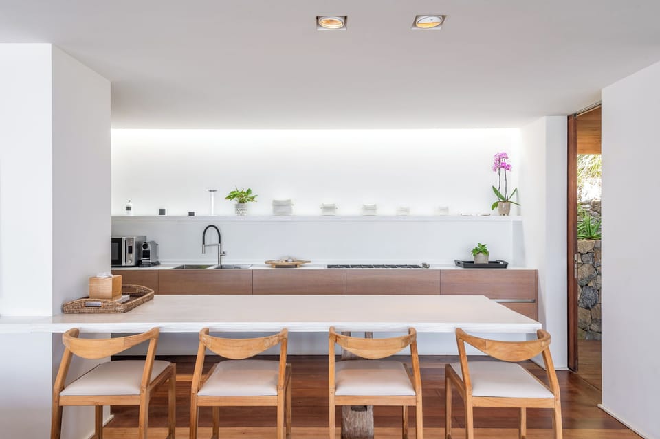 Modern and fully equipped kitchen. Coffee machine, dishwasher, espresso machine, gas cooker, microwave oven, oven, wine cellar. Dining area in the great room with a large rectangular wood table for 8-10 guests. A second dining table is available by the ba