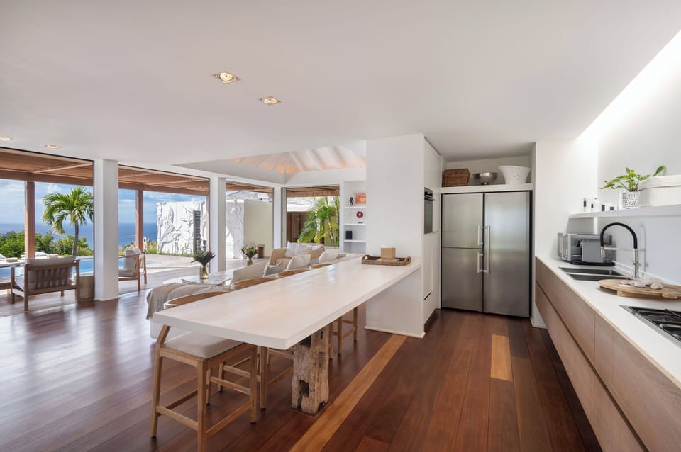 Modern and fully equipped kitchen. Coffee machine, dishwasher, espresso machine, gas cooker, microwave oven, oven, wine cellar. Dining area in the great room with a large rectangular wood table for 8-10 guests. A second dining table is available by the ba