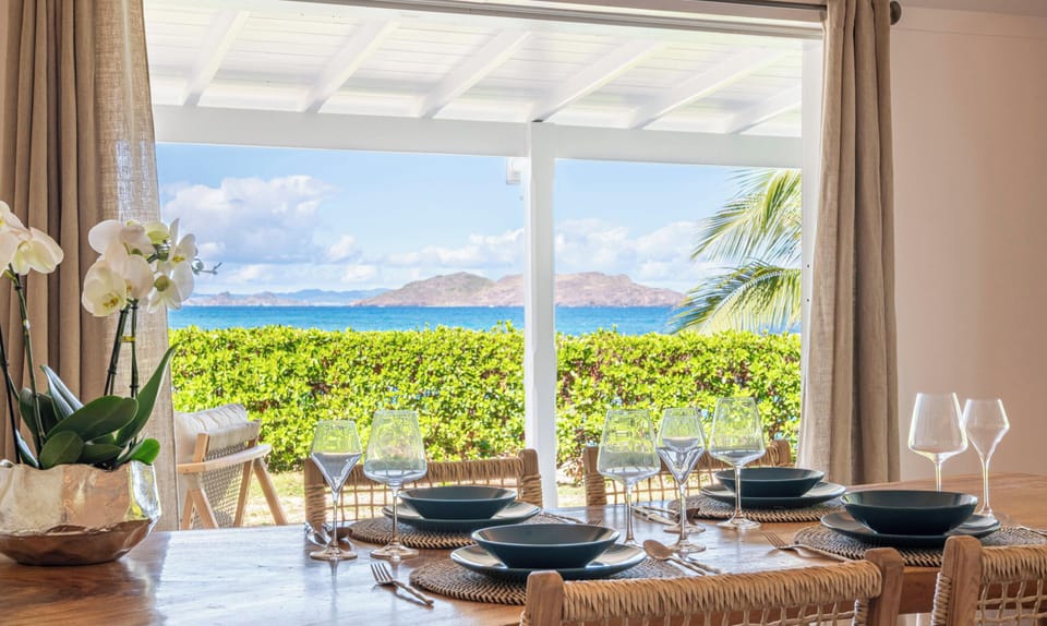 Open-air fully equipped kitchen. Electric oven, gas stove, microwave, refrigerator, mixer, freezer, dishwasher, Nespresso machine, blender, kettle, toaster, breakfast bar. Indoor dining table and dining area on the covered terrace. 