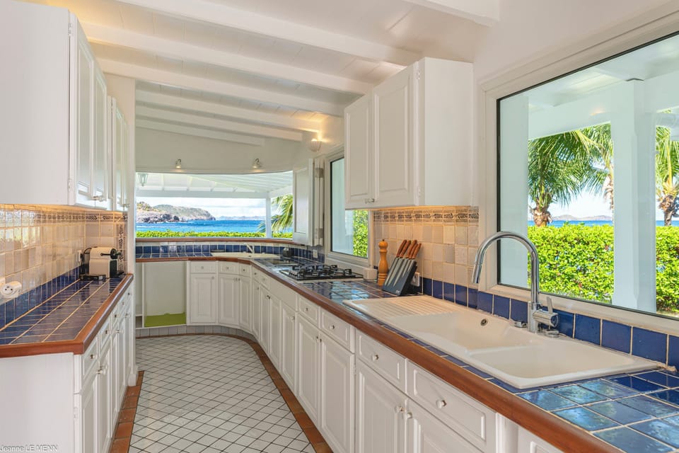 Open-air fully equipped kitchen. Electric oven, gas stove, microwave, refrigerator, mixer, freezer, dishwasher, Nespresso machine, blender, kettle, toaster, breakfast bar. Indoor dining table and dining area on the covered terrace. 
