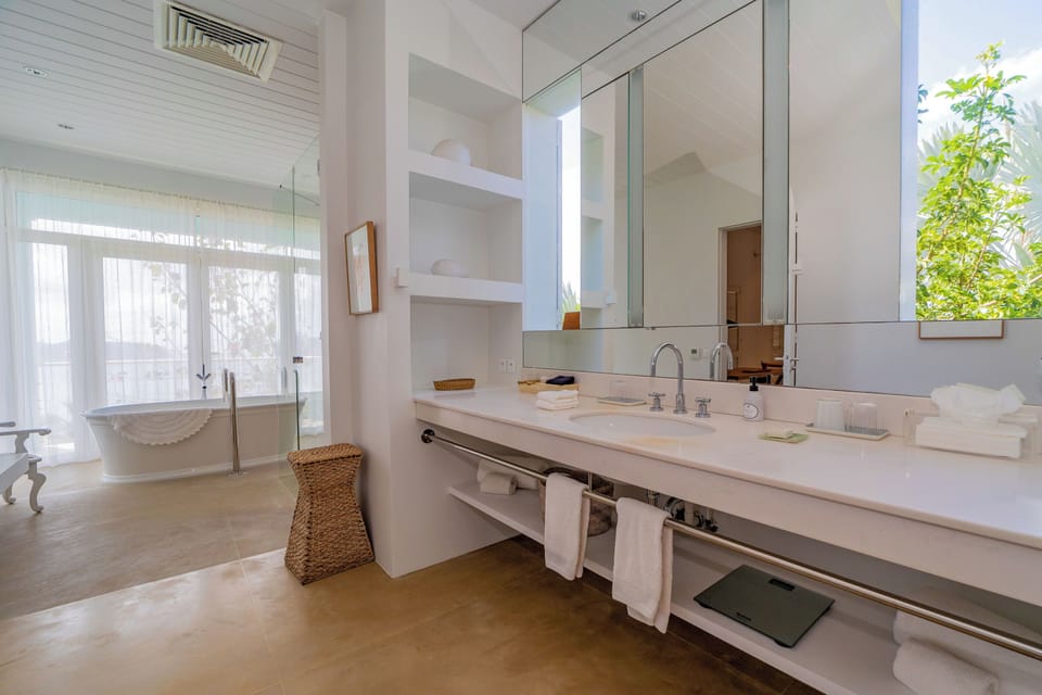 Four poster king size bed, air conditioning, ceiling fan, desk, safe and small fridge. Ensuite bathroom with regular shower and bathtub, wash basin, hairdryer, bathrobes, towels and beach towels, welcome products, dressing. Separate toilets. Direct pool a