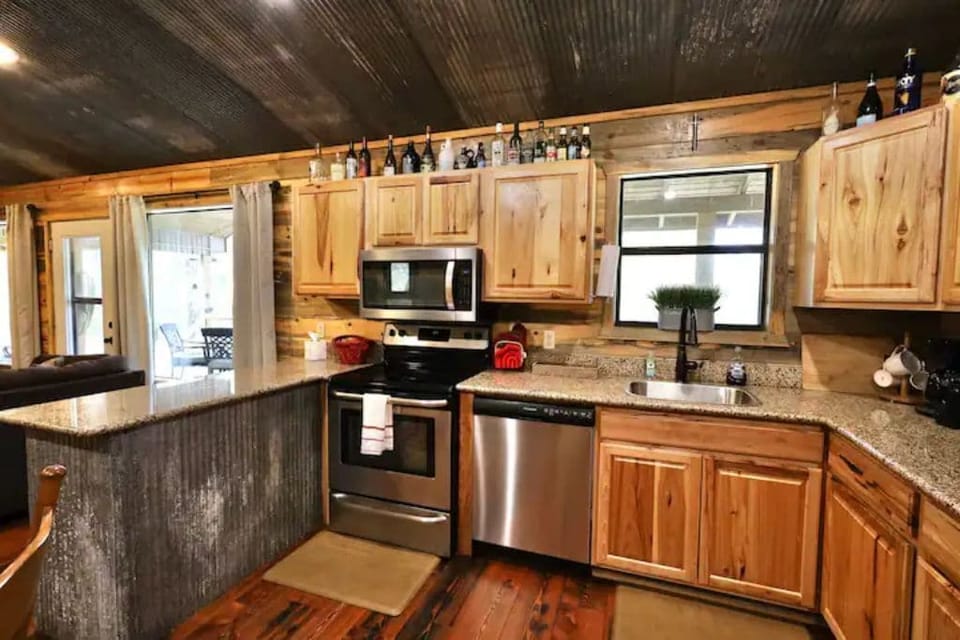 Fully socked kitchen with stove/oven, dishwasher, refrigerator, microwave.