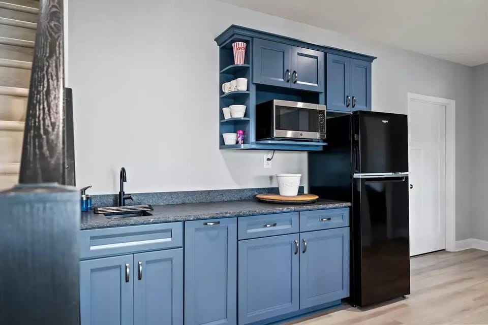 Basement kitchenette with fridge/freezer, microwave, and coffee maker.
