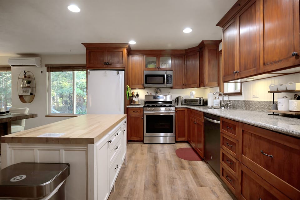 Large chef's kitchen with island for extra counter space. Refridgerator with icemaker, air fryer, and an eco-friendly coffee station make cooking easy.