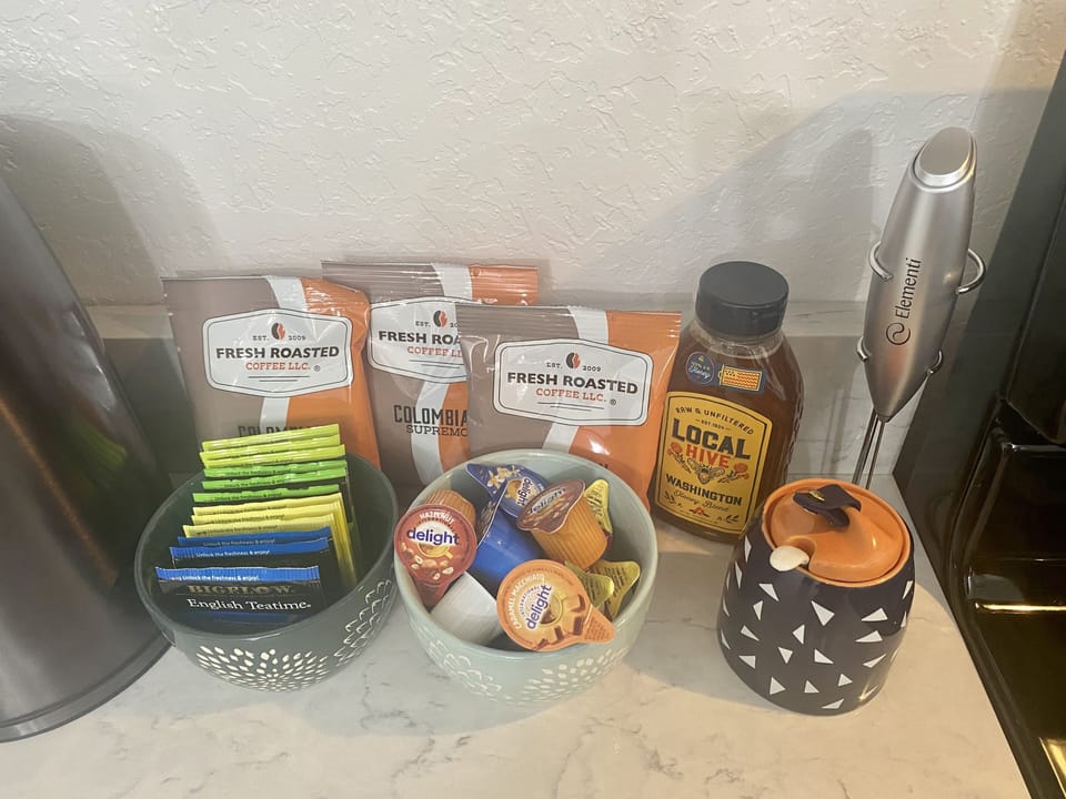 Coffee/tea bar stocked with a variety of teas, creamers, local honey, coffee. 