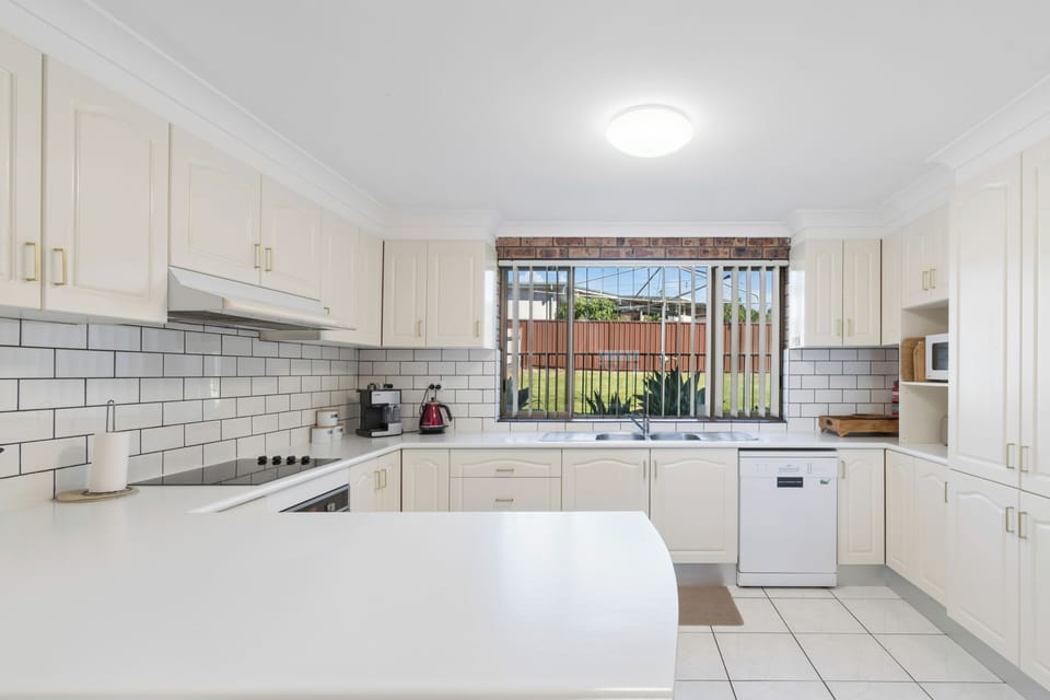 The kitchen is fully equipped for effortless holiday hosting, featuring a fridge, oven, stove, microwave, and dishwasher—everything needed to cook, serve, and clean up with ease.