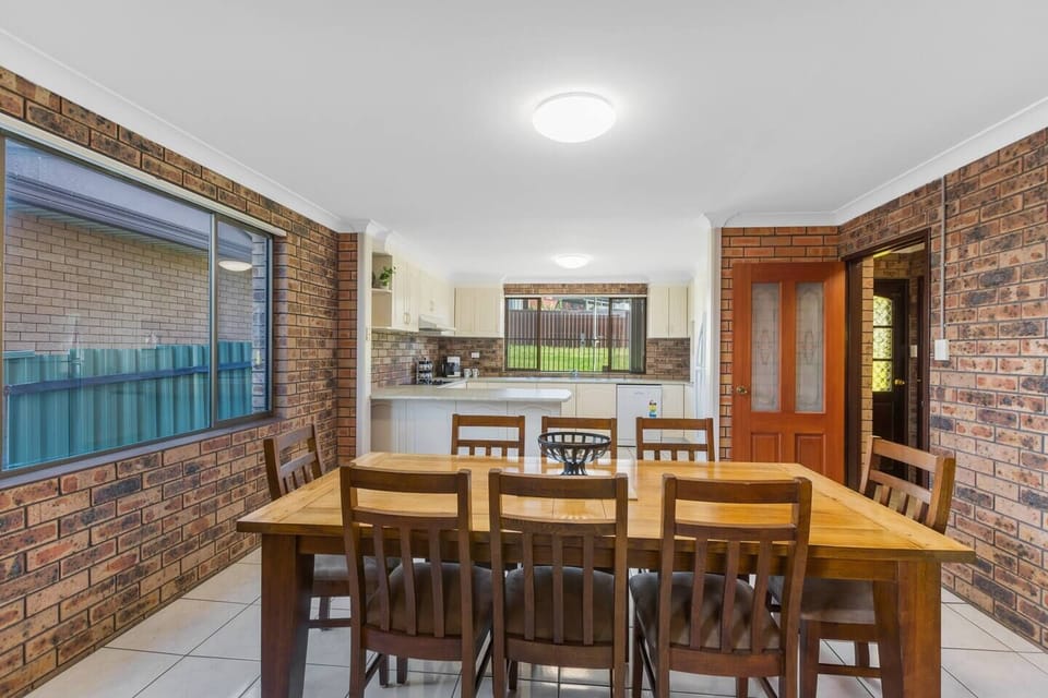 Sit down together for meals at home at an eight-person dining table located beside the kitchen.
