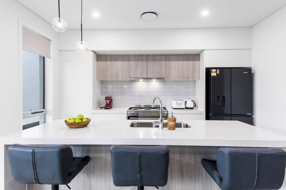 The well-equipped kitchen has all you need to cook up meals at home, as well as seating at the kitchen island and an eight-seater dining table. 
