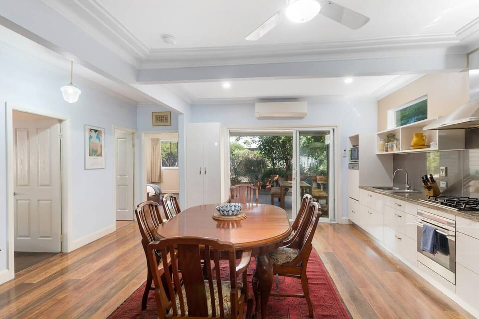 Gather around the large table and enjoy delicious food and great conversation in the light-filled dining room.