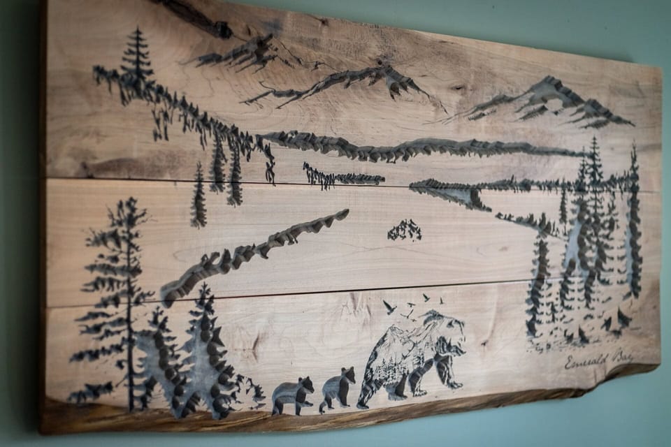 - Mountain artwork carved in wood  
- Rustic décor with Tahoe wilderness style  
- Unique detail in vacation rental design