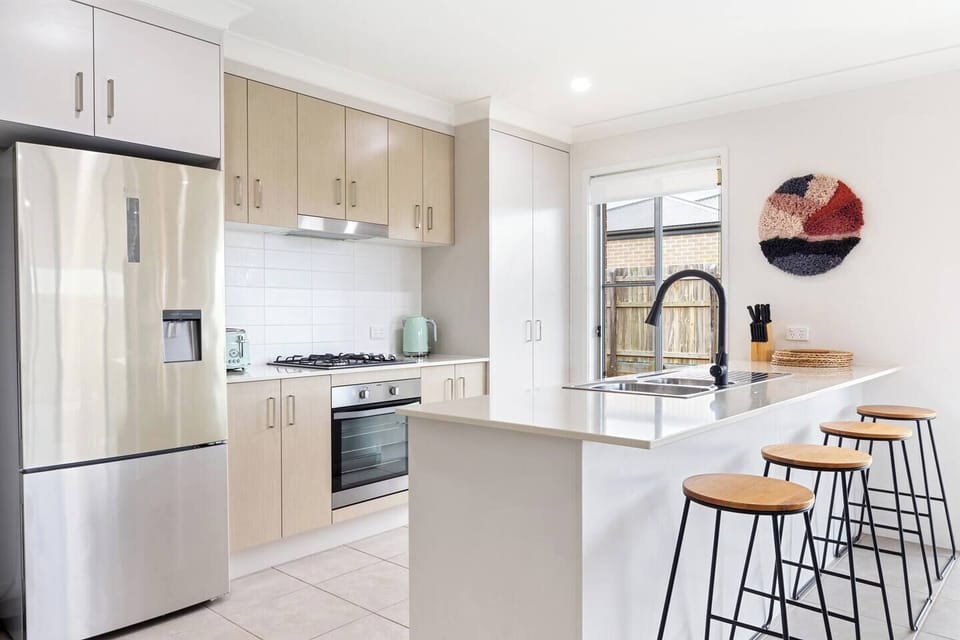 The modern kitchen is designed around a centrepiece island bench, where you can prepare meals, socialise or enjoy slow mornings at home.