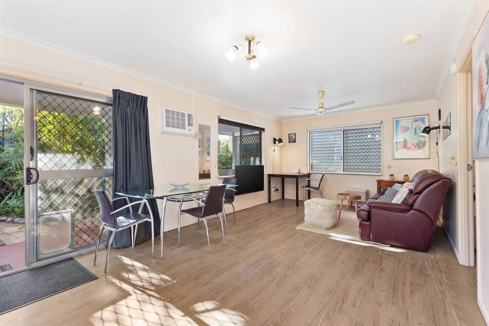 The dining and lounge area offers a three-seater couch, smart TV, heating and cooling, plus a dedicated workspace