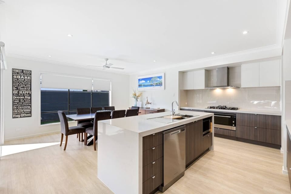 Cook, connect and entertain with ease around the generous island, where contemporary finishes and quality appliances make every meal a pleasure.