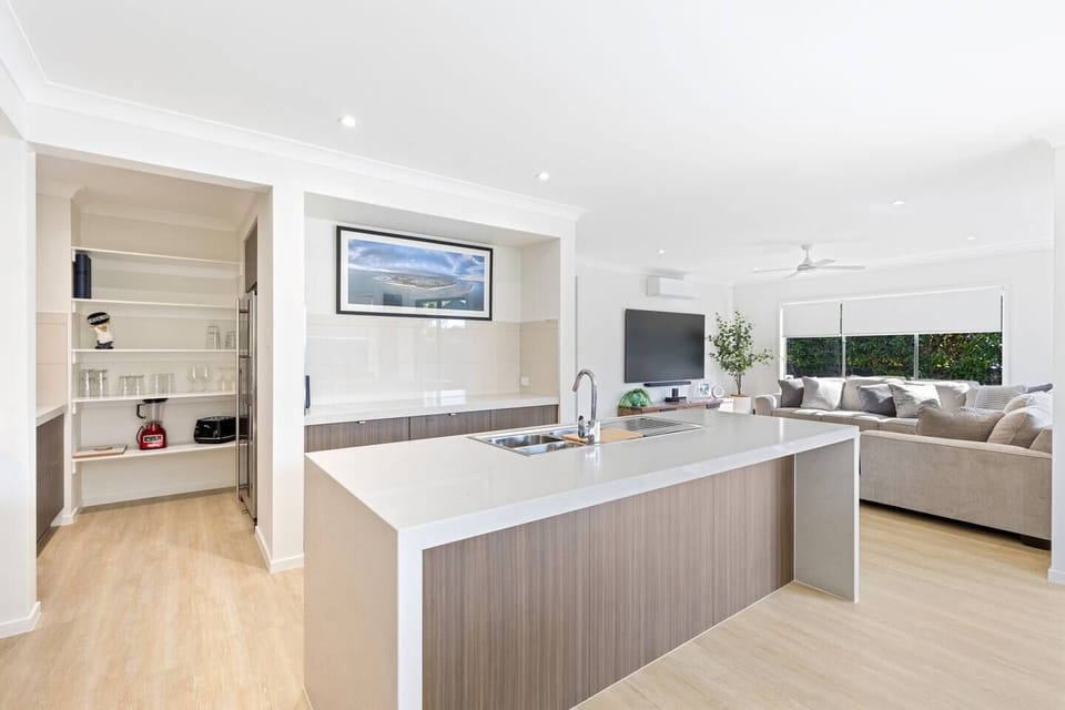 The walk-in pantry and abundant cabinetry provide practical storage, while the large French-door refrigerator ensures plenty of room for family groceries and holiday treats.