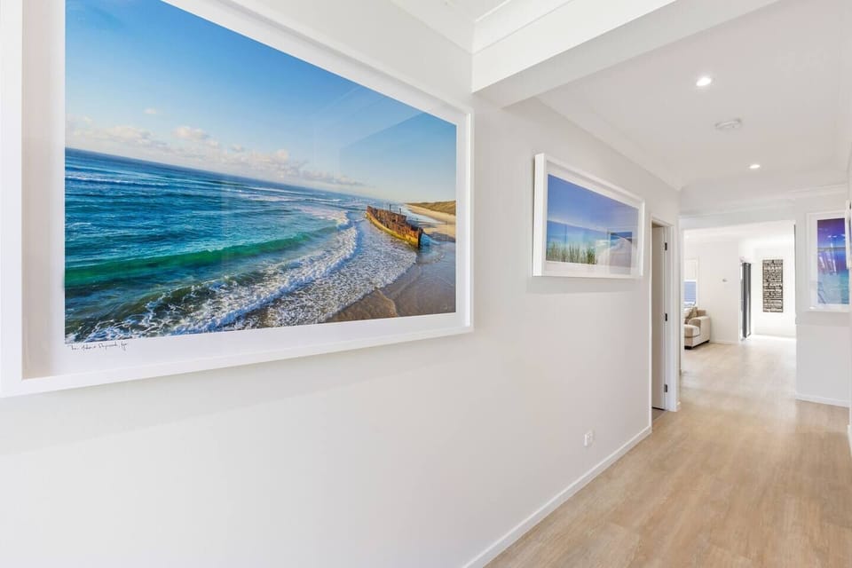 In the entrance of the house, stunning ocean themed photographic art is mounted on the walls in large beautiful frames putting you in holiday mode from the moment you step foot inside. 