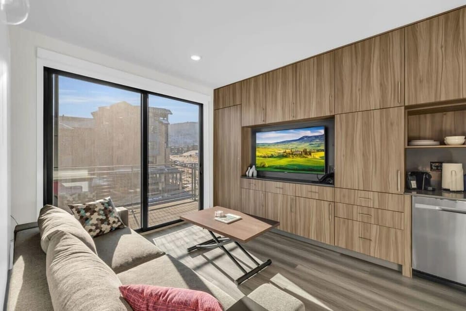 The dynamic living space can be used for a relaxing movie night before turning into a sleeping area with a pull-out queen bed and pull-out bunk beds.