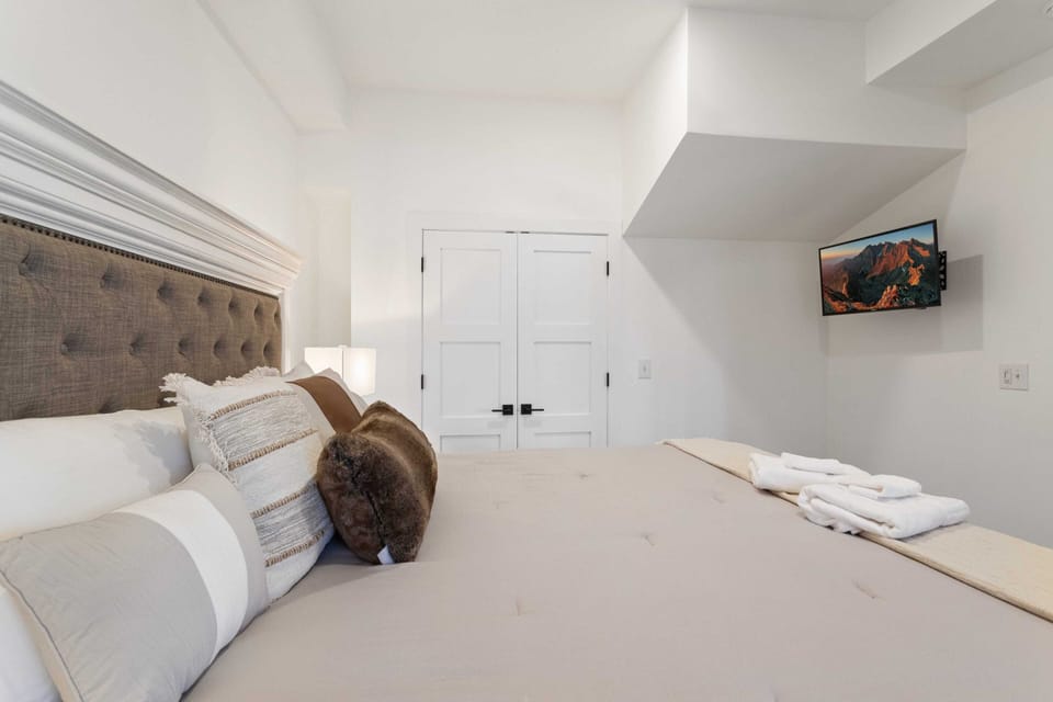 King Bed, TV, and Ensuite Bathroom in the Lower Level Master Bedroom