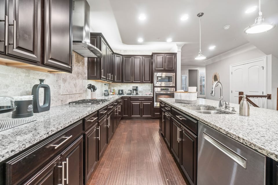 Large, well-stocked kitchen with stainless steel appliances