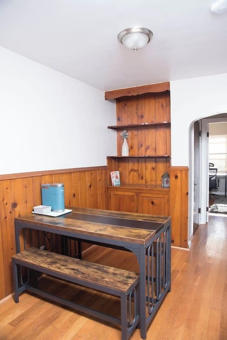 Kitchen table with bench seating and Keurig coffee maker.
